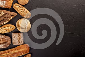 Arrangement of bread buns and loavesÂ on black
